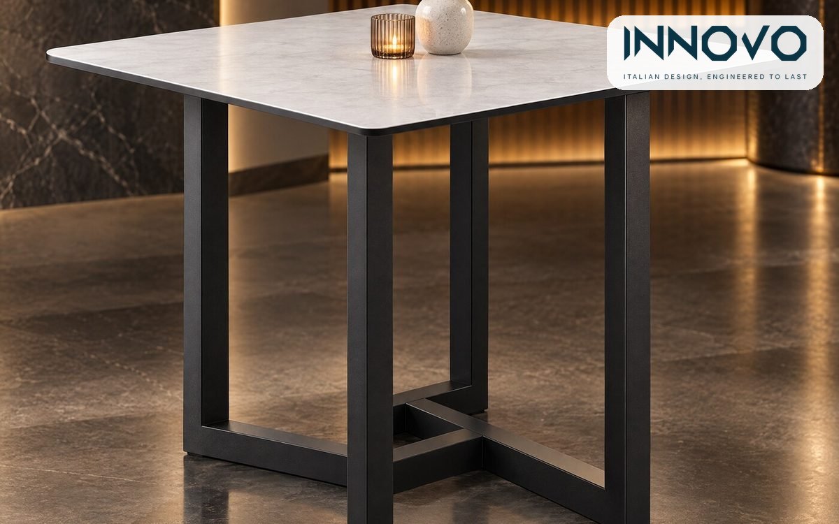 INNOVO showroom table with a grey stone-look top on an interlocking black steel frame